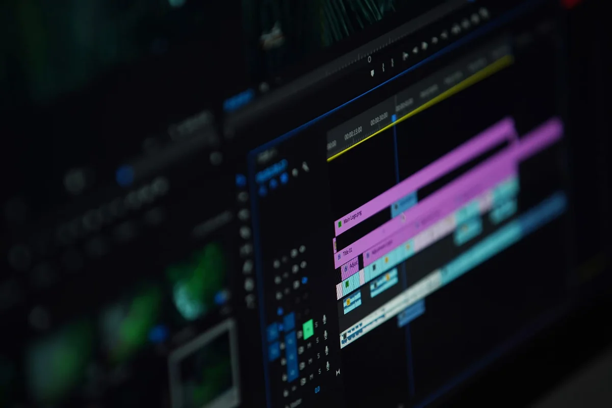 Video editing timeline with video and audio tracks on a dark screen